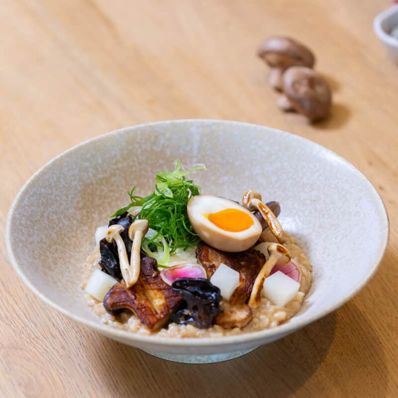 Congee dish with sot boiled egg and mushrooms